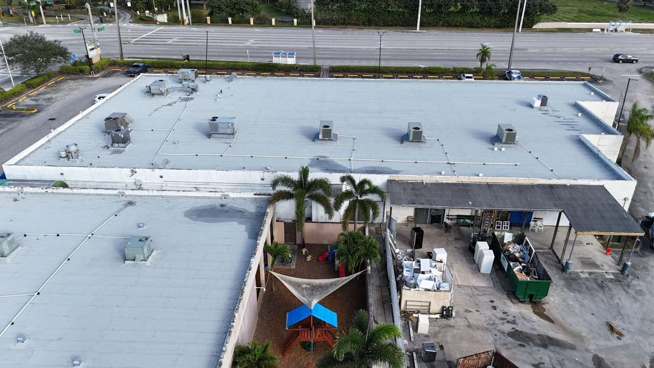 Aerial view of commercial building roof with HVAC units