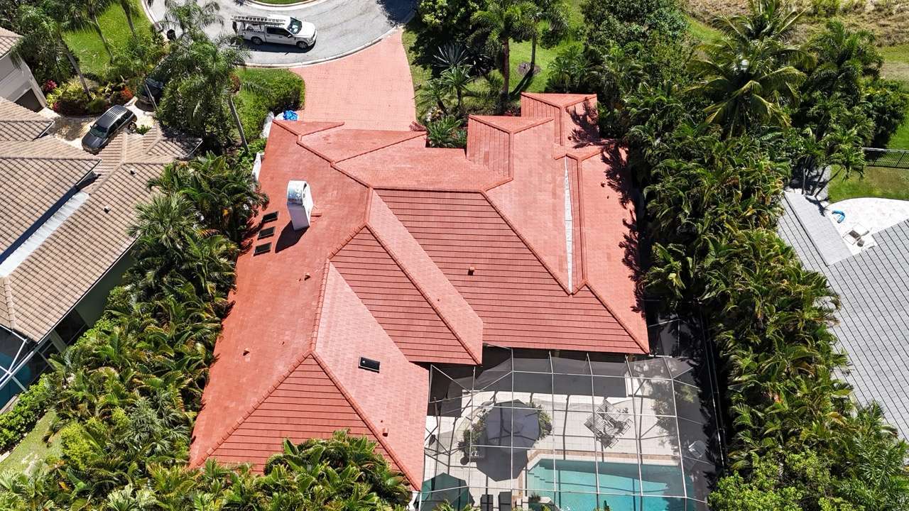 Aerial view of a large house with red tile roof