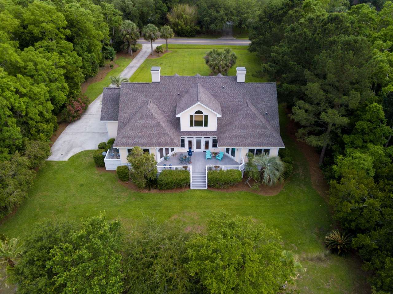 Aerial view of a large suburban home with pool